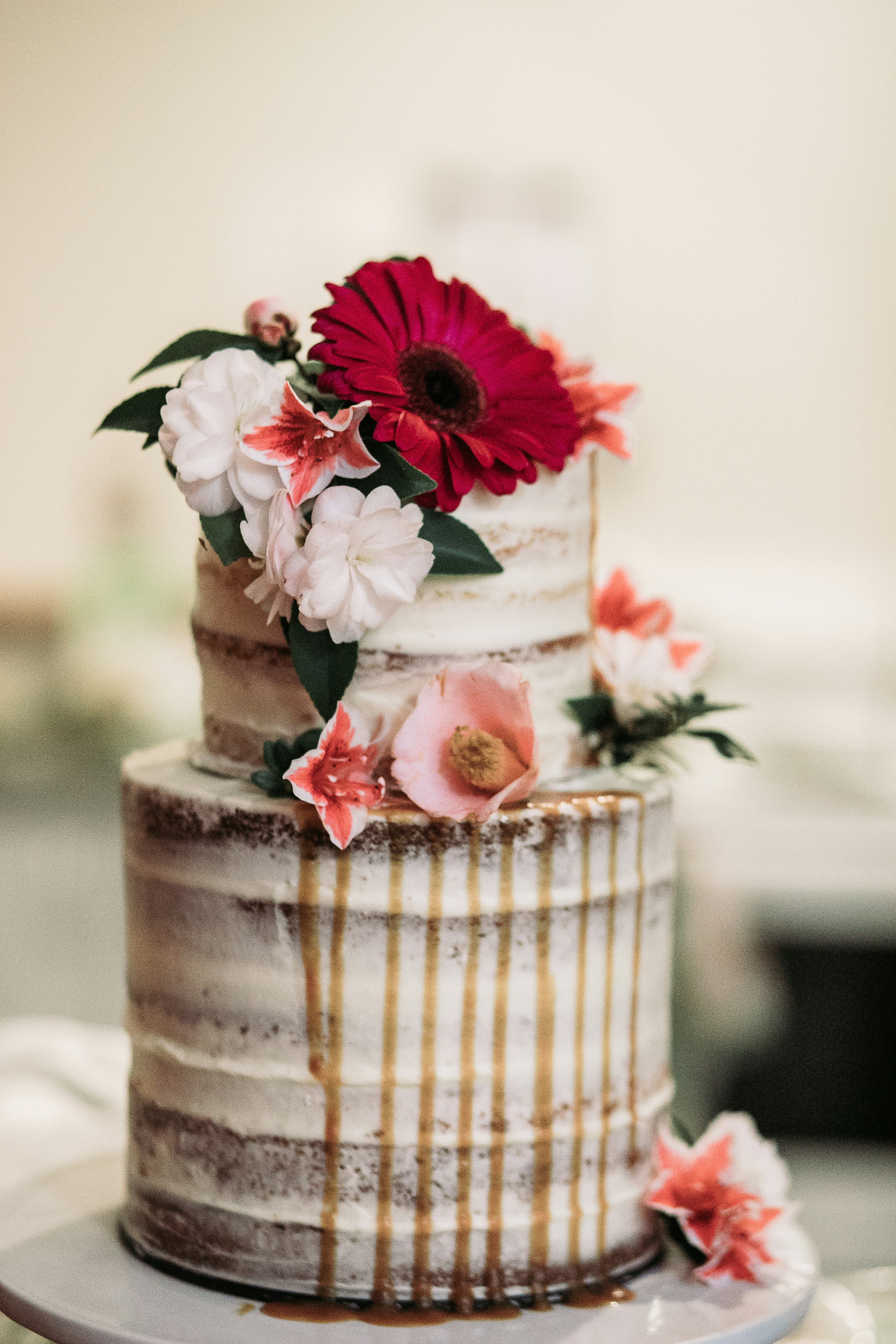 white icing-covered cake with flowers on top